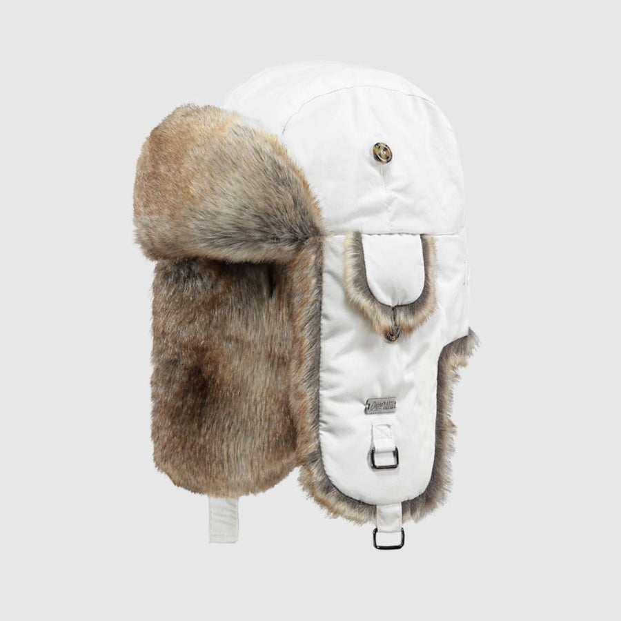 White winter hat with fur ear flaps on a light gray background